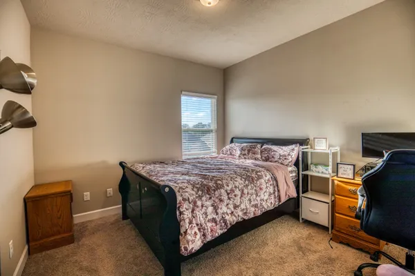 a bedroom with a bed and a tv