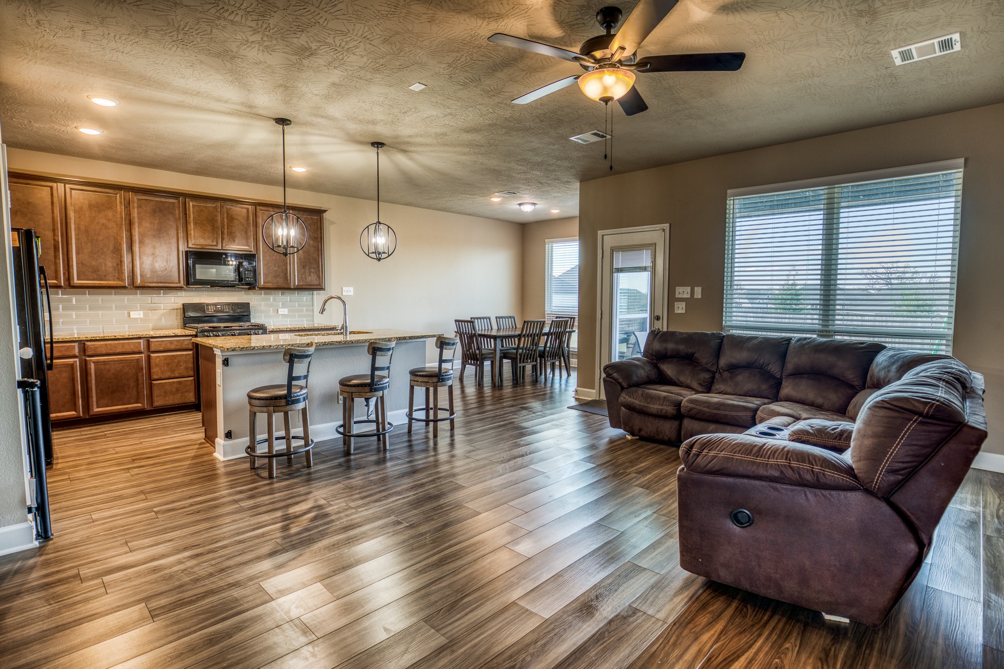 2004 Vineyard Pass Brenham, TX 77833 - Photo 6 of 37 a living room with stainless steel appliances kitchen island furniture and a wooden floor