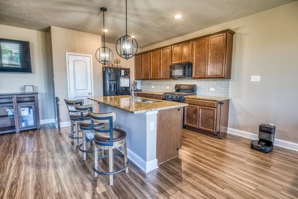 a large kitchen with a table and chairs in it