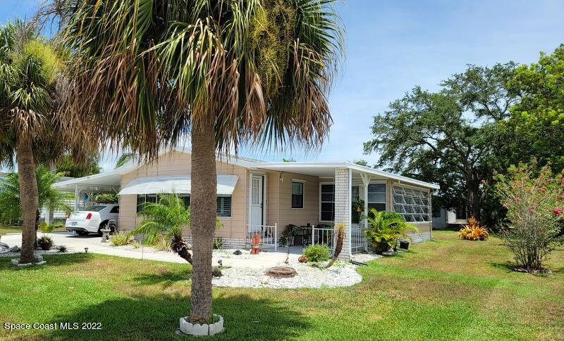 a view of a house with backyard porch and sitting area