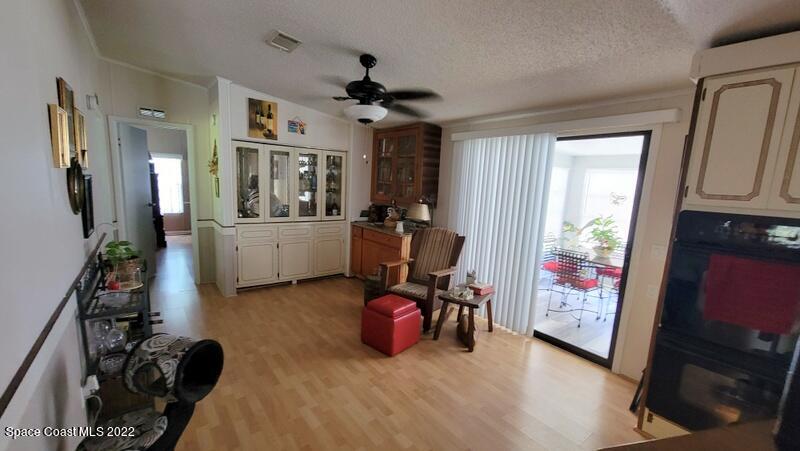 926 Yew Street Sebastian, FL 32976 - Photo 12 of 36 a view of a livingroom with furniture hardwood floor and a ceiling fan