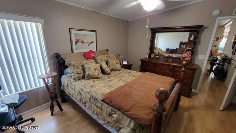 926 Yew Street Sebastian, FL 32976 - Photo 13 of 36 a bedroom with a bed and a mirror