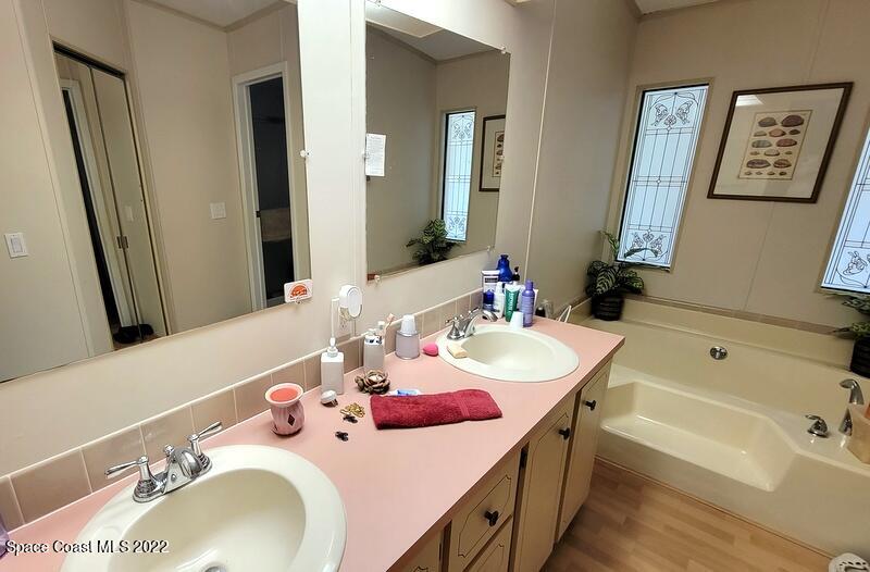 926 Yew Street Sebastian, FL 32976 - Photo 15 of 36 a bathroom with a tub sink and mirror