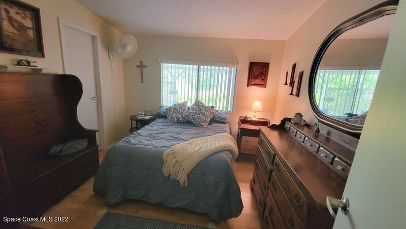 926 Yew Street Sebastian, FL 32976 - Photo 17 of 36 a bedroom with bed mirror and window