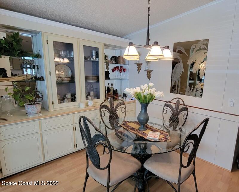 926 Yew Street Sebastian, FL 32976 - Photo 9 of 36 a dining room filled chandelier and wooden floor