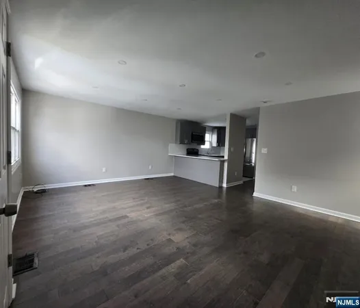 an empty room with empty space wooden floor and windows
