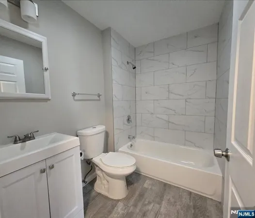 a white toilet sitting next to a bath tub