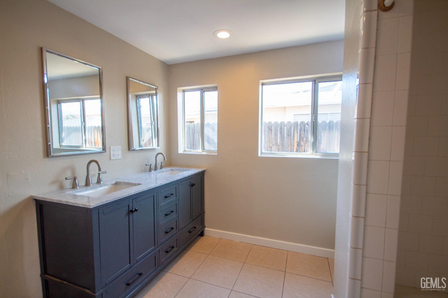 Undisclosed Address Bakersfield, CA 93305 - Photo 12 of 20 a bathroom with 2 sink tub and a mirror
