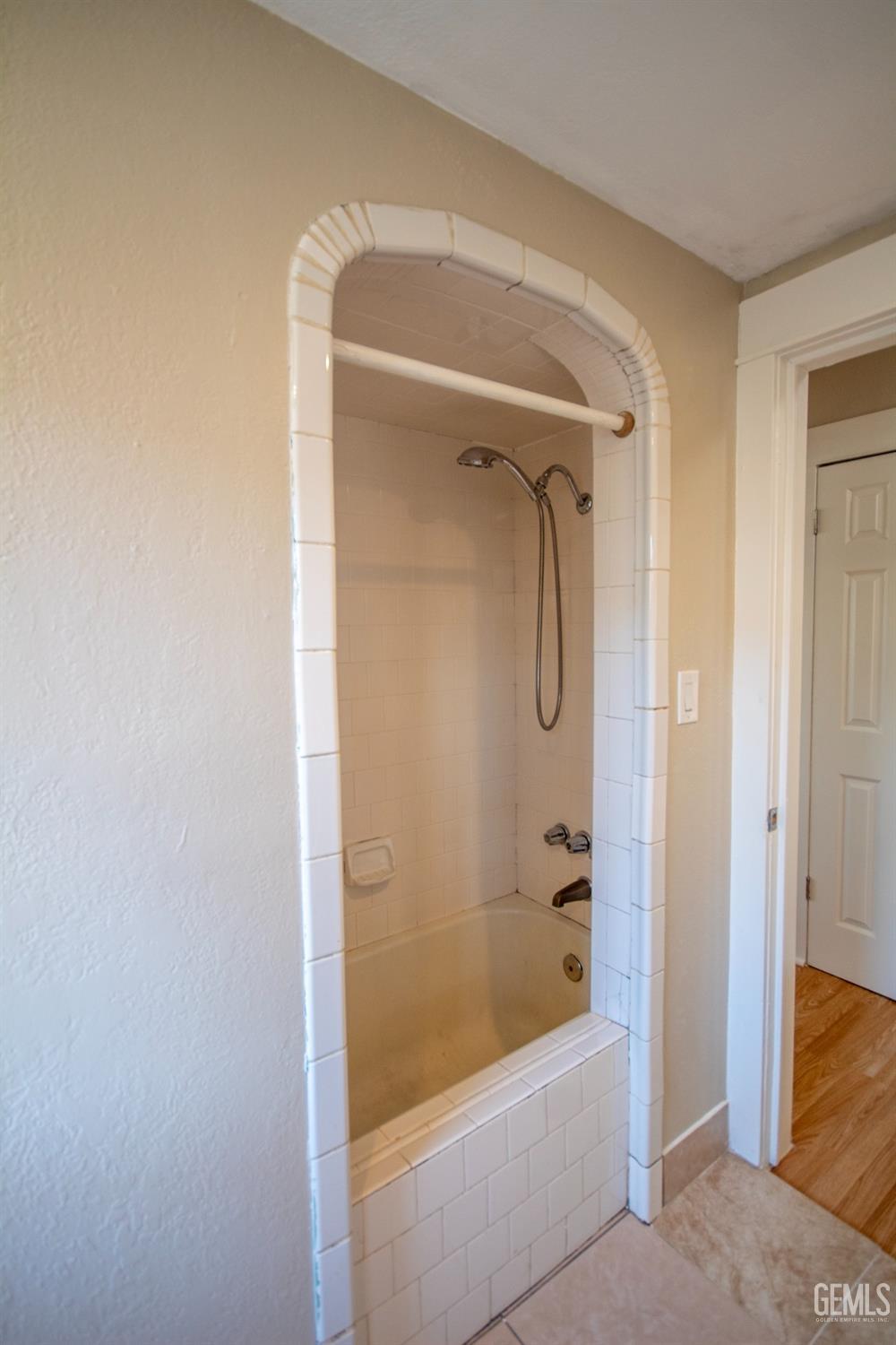 Undisclosed Address Bakersfield, CA 93305 - Photo 13 of 20 a bathroom with a tub and a shower