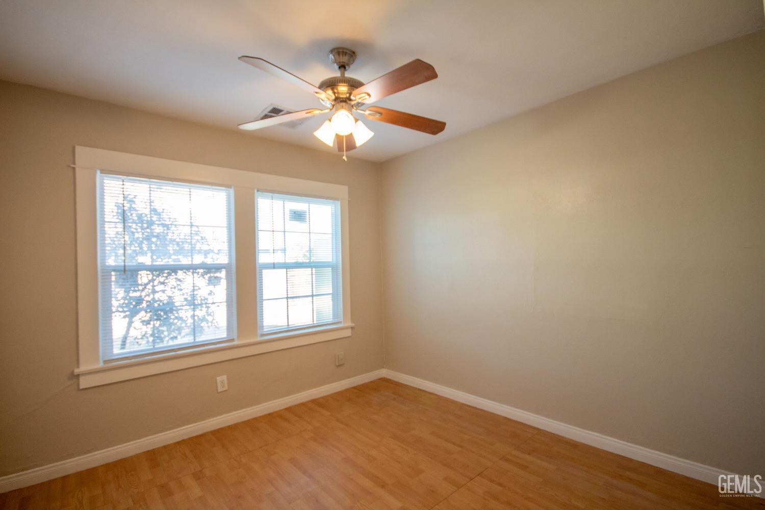Undisclosed Address Bakersfield, CA 93305 - Photo 15 of 20 an empty room with windows and fan