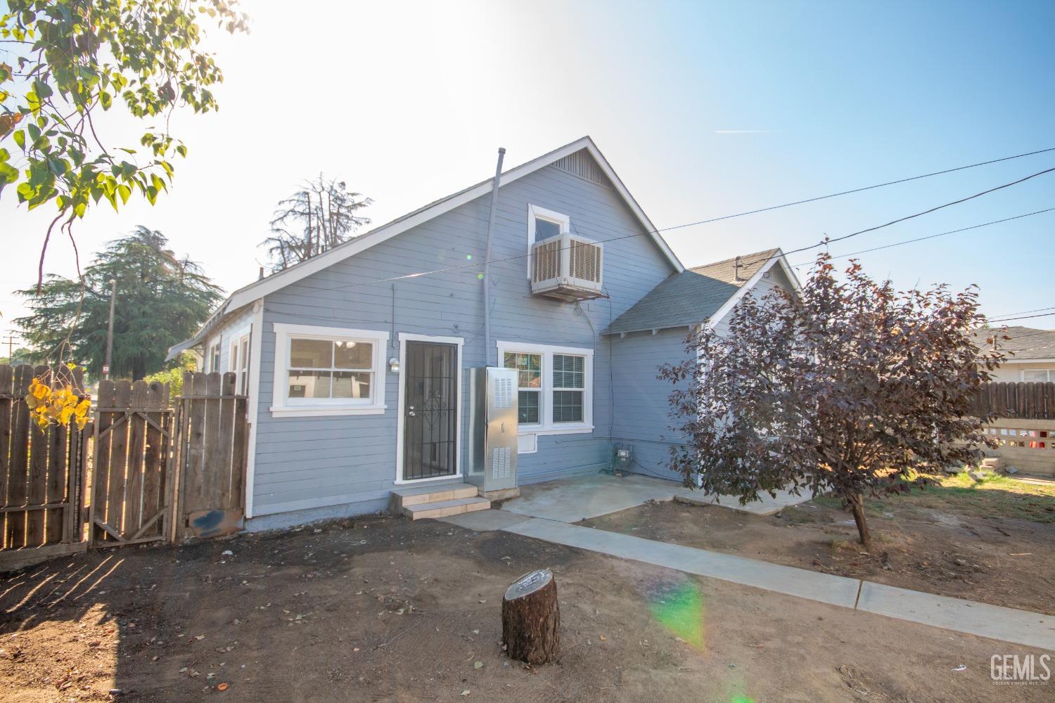 Undisclosed Address Bakersfield, CA 93305 - Photo 17 of 20 a front view of a house with a yard and garage