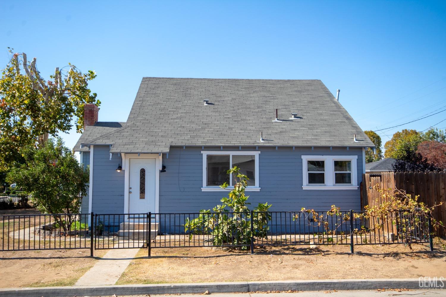 Undisclosed Address Bakersfield, CA 93305 - Photo 19 of 20 a front view of a house with a garden