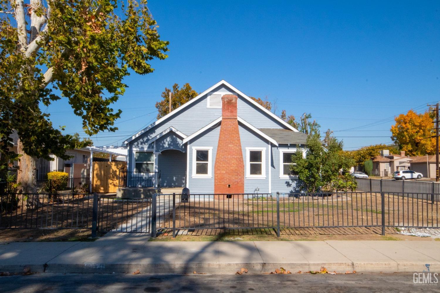 Undisclosed Address Bakersfield, CA 93305 - Photo 2 of 20 a front view of a house with a garden