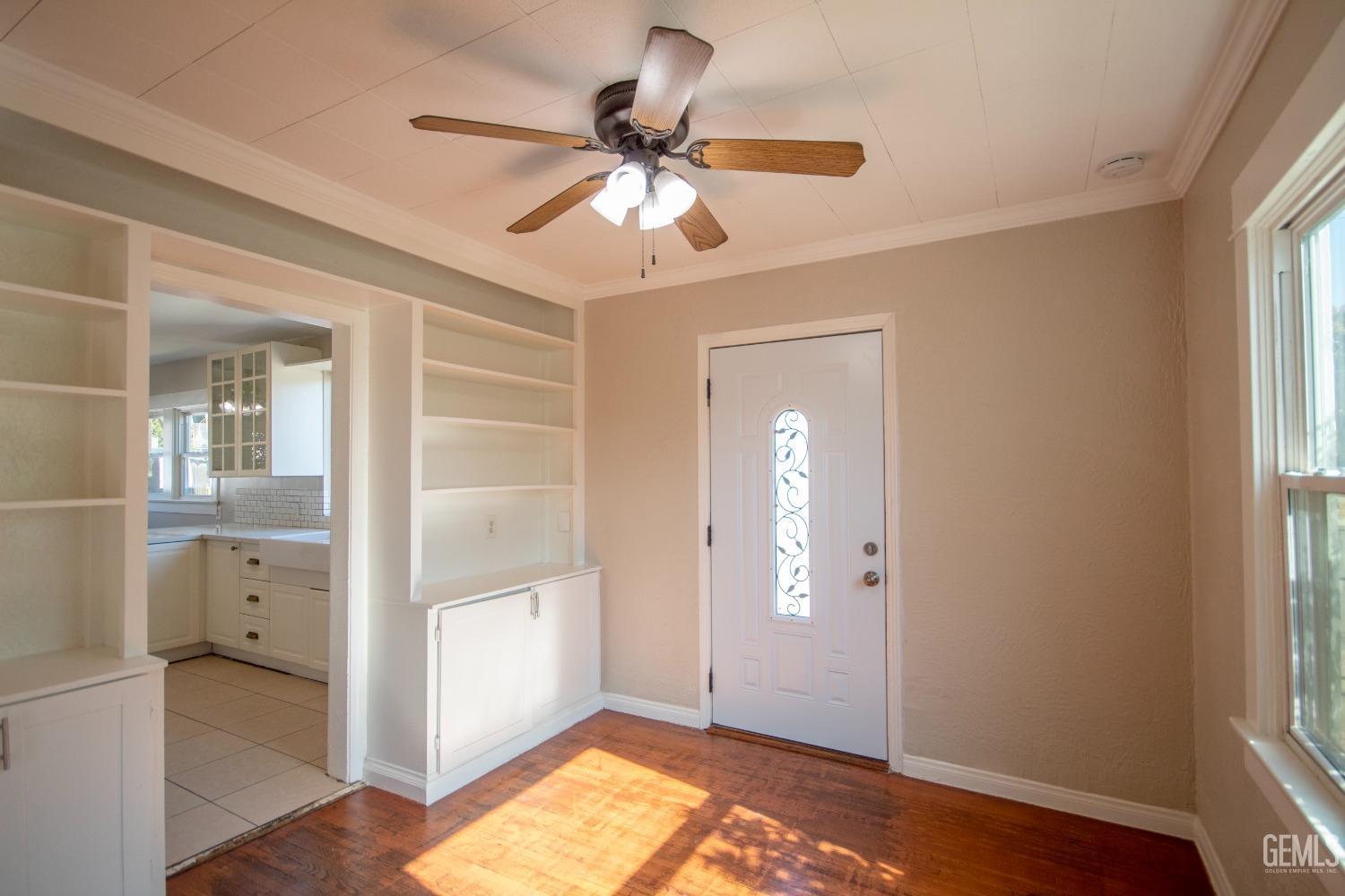 Undisclosed Address Bakersfield, CA 93305 - Photo 7 of 20 a view of empty room with wooden floor and fan