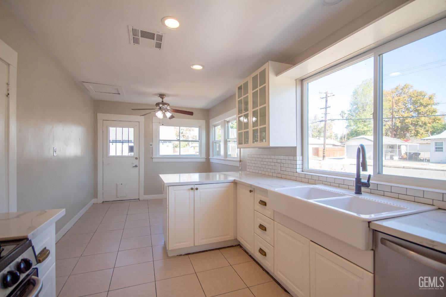 Undisclosed Address Bakersfield, CA 93305 - Photo 9 of 20 a large white kitchen with a window