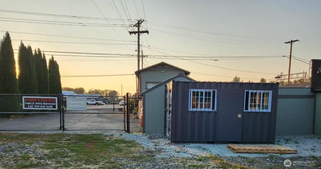 a view of a house with a door and wooden walls