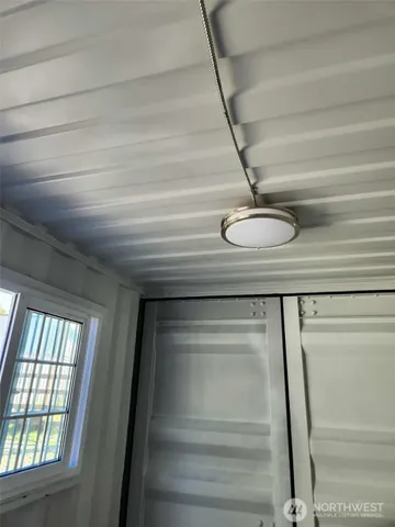 a view of walk in closet with window and outdoor view