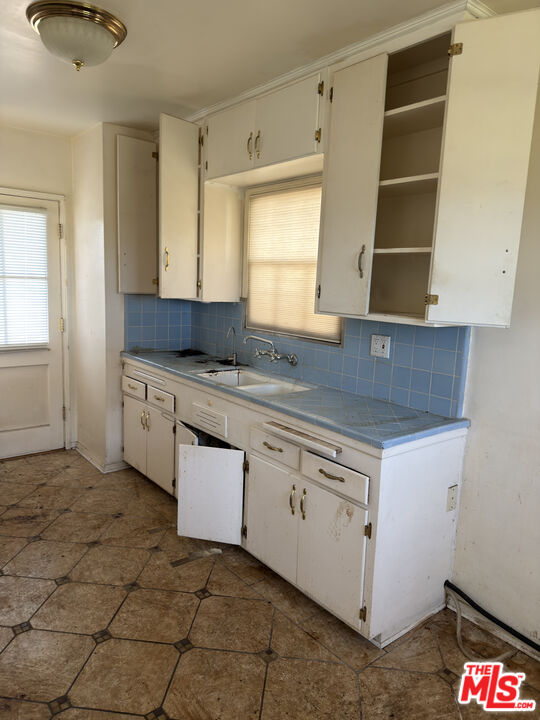 8230 Kyle Street Sunland, CA 91040 - Photo 9 of 13 a kitchen with granite countertop a sink and a stove