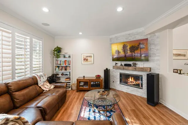 a living room with furniture a flat screen tv and a fireplace