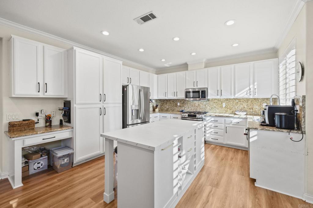 3033 Rancho La Presa Carlsbad, CA 92009 - Photo 12 of 46 a kitchen with refrigerator a stove a sink and wooden floor