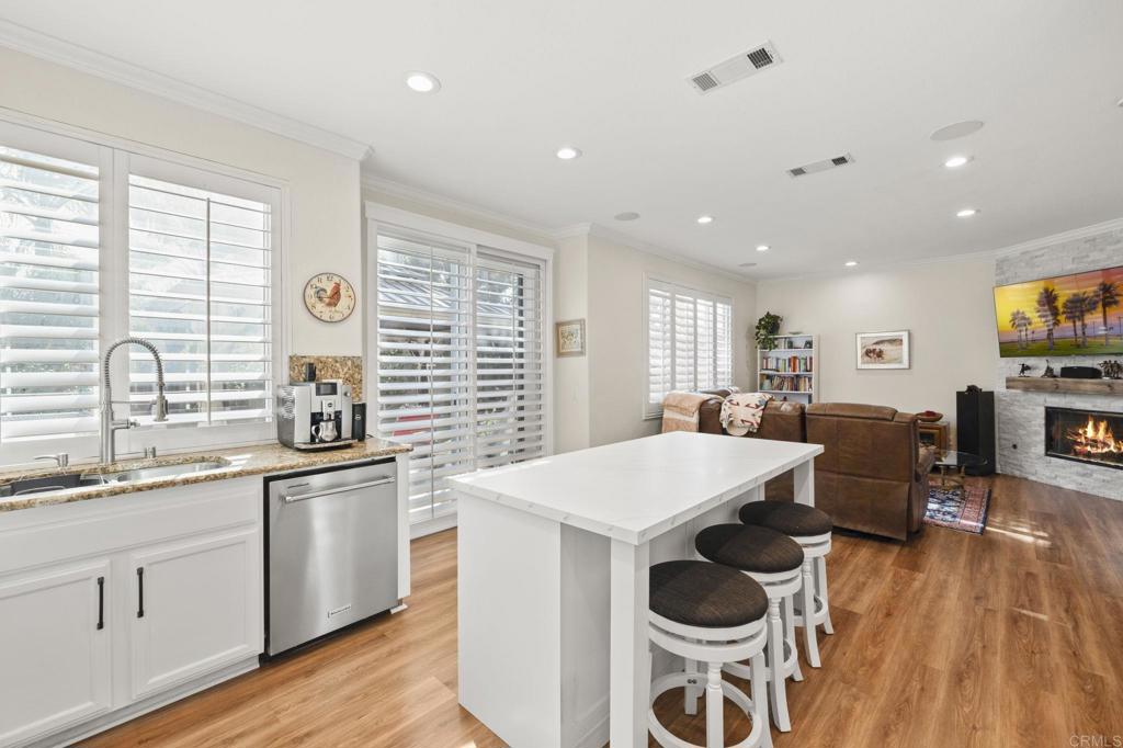 3033 Rancho La Presa Carlsbad, CA 92009 - Photo 13 of 46 a large white kitchen with a large window