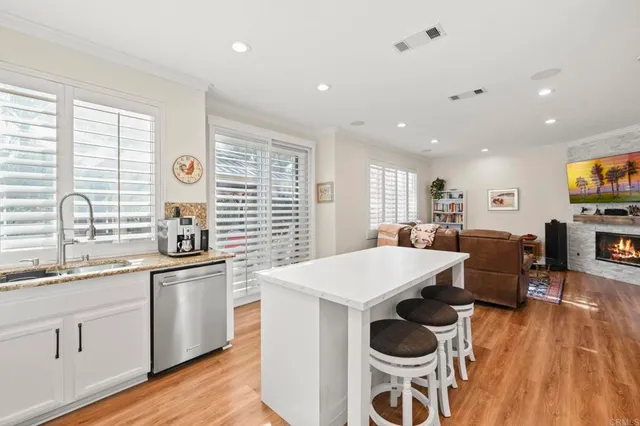 a large white kitchen with a large window