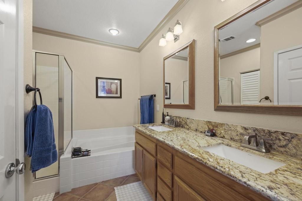 3033 Rancho La Presa Carlsbad, CA 92009 - Photo 19 of 46 a bathroom with a granite countertop double vanity sink and mirror