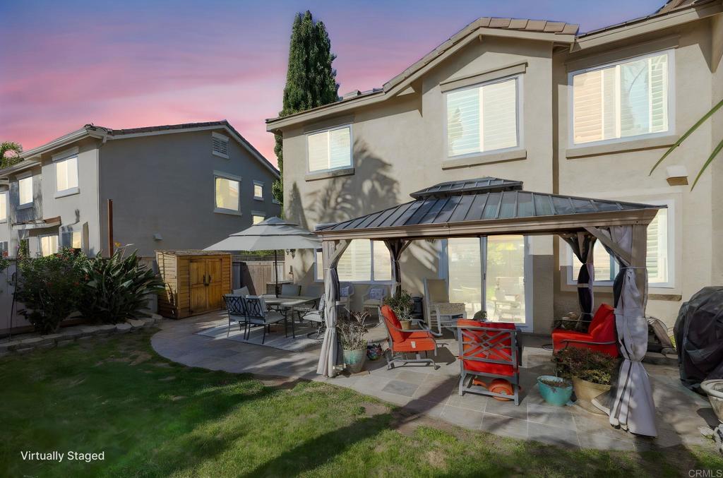 3033 Rancho La Presa Carlsbad, CA 92009 - Photo 26 of 46 a view of a patio with table and chairs under an umbrella