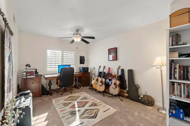 a view of a workspace with furniture and a window