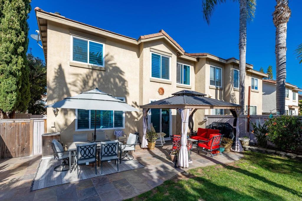 3033 Rancho La Presa Carlsbad, CA 92009 - Photo 27 of 46 a view of a patio with a table and chairs under an umbrella