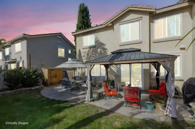 a view of a patio with table and chairs under an umbrella
