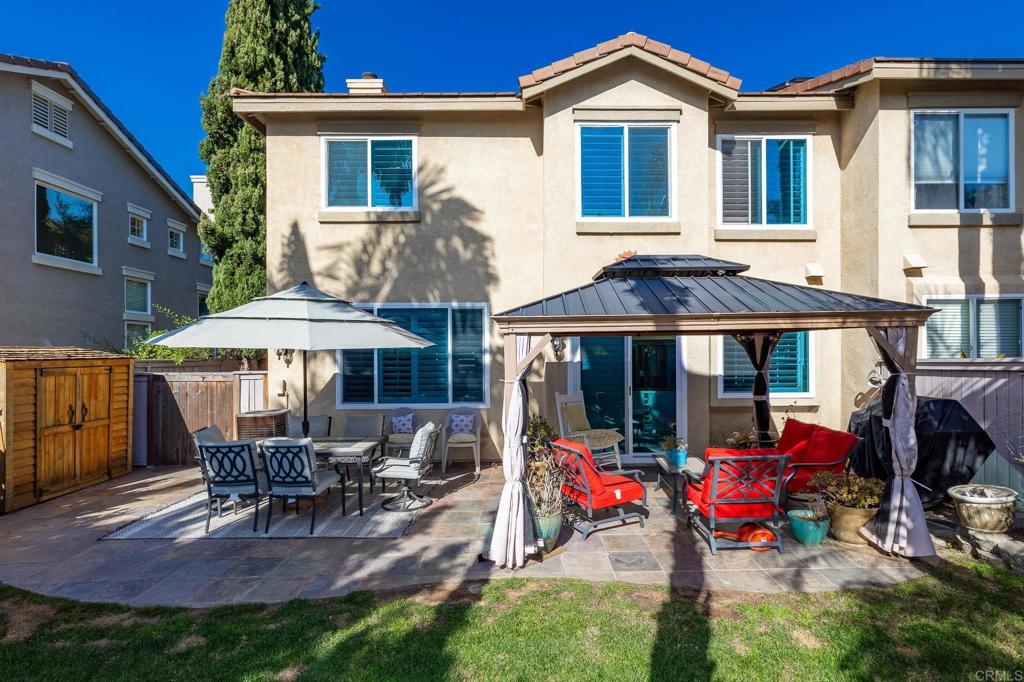 3033 Rancho La Presa Carlsbad, CA 92009 - Photo 29 of 46 a view of a house with a patio and a garden