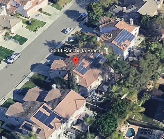 an aerial view of a house with garden space and street view