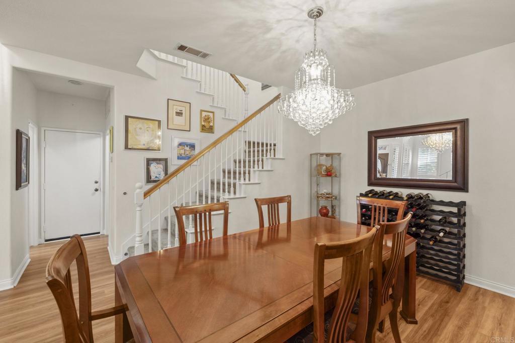 3033 Rancho La Presa Carlsbad, CA 92009 - Photo 9 of 46 a view of a dining room with furniture wooden floor and chandelier