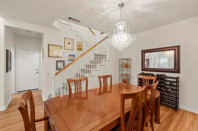 a view of a dining room with furniture wooden floor and chandelier