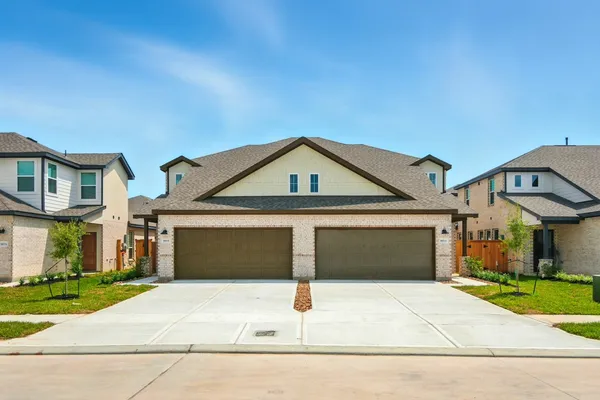 a front view of a house with garage