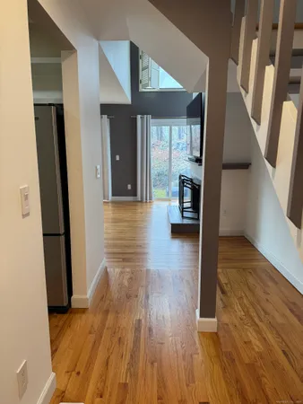 a view of a hallway view with wooden floor and staircase