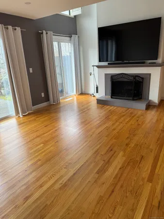 a view of a livingroom with an empty space and a fireplace
