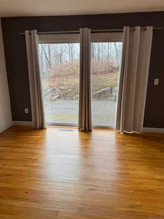 a view of wooden floor and windows in a room