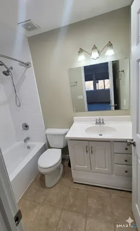 a bathroom with a sink toilet a mirror and bathtub