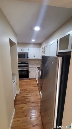 a kitchen with stainless steel appliances a refrigerator and a stove