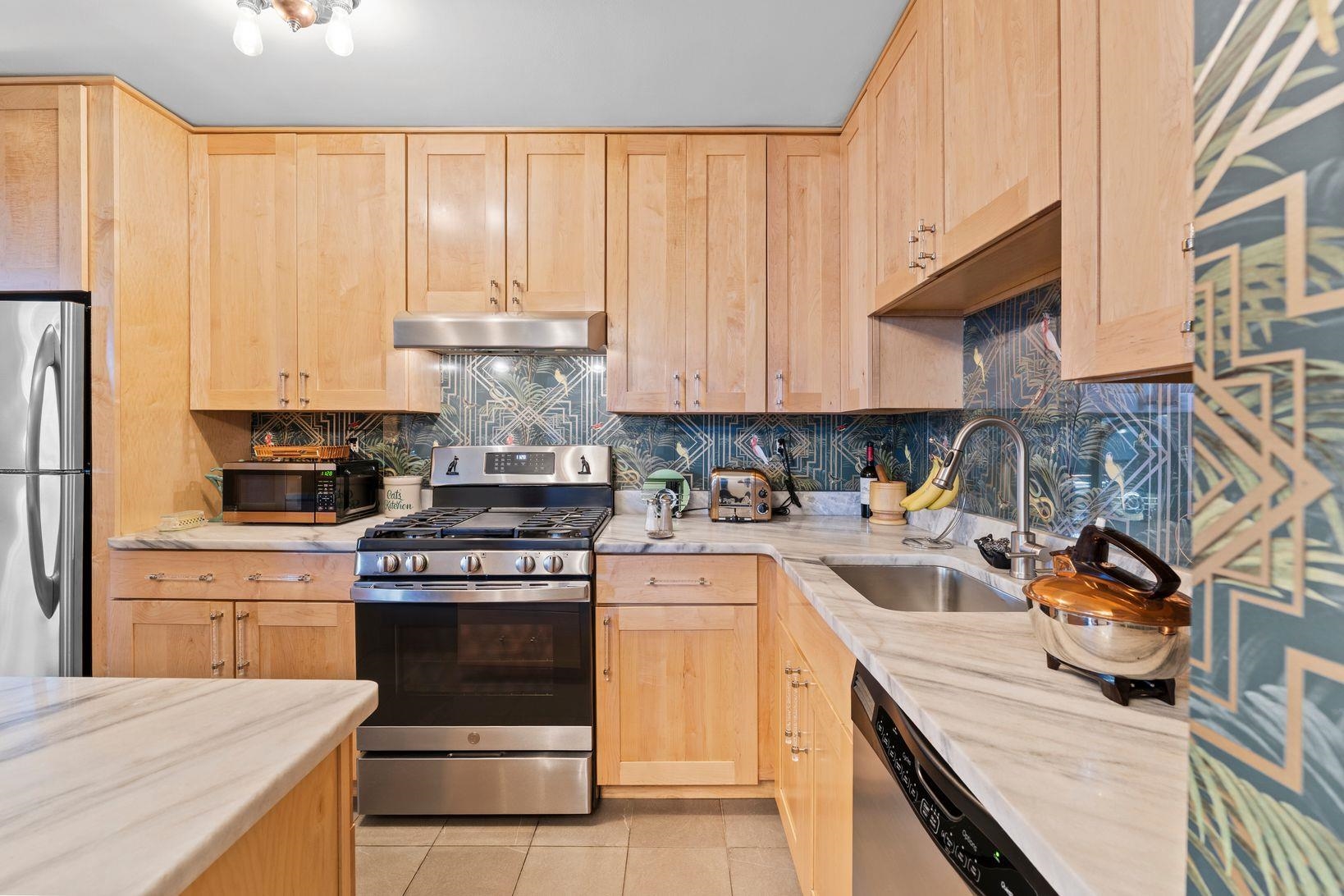 6040 Boulevard East, Unit MA West New York, NJ 07093 - Photo 12 of 35 a kitchen with stainless steel appliances granite countertop a stove and a white cabinets