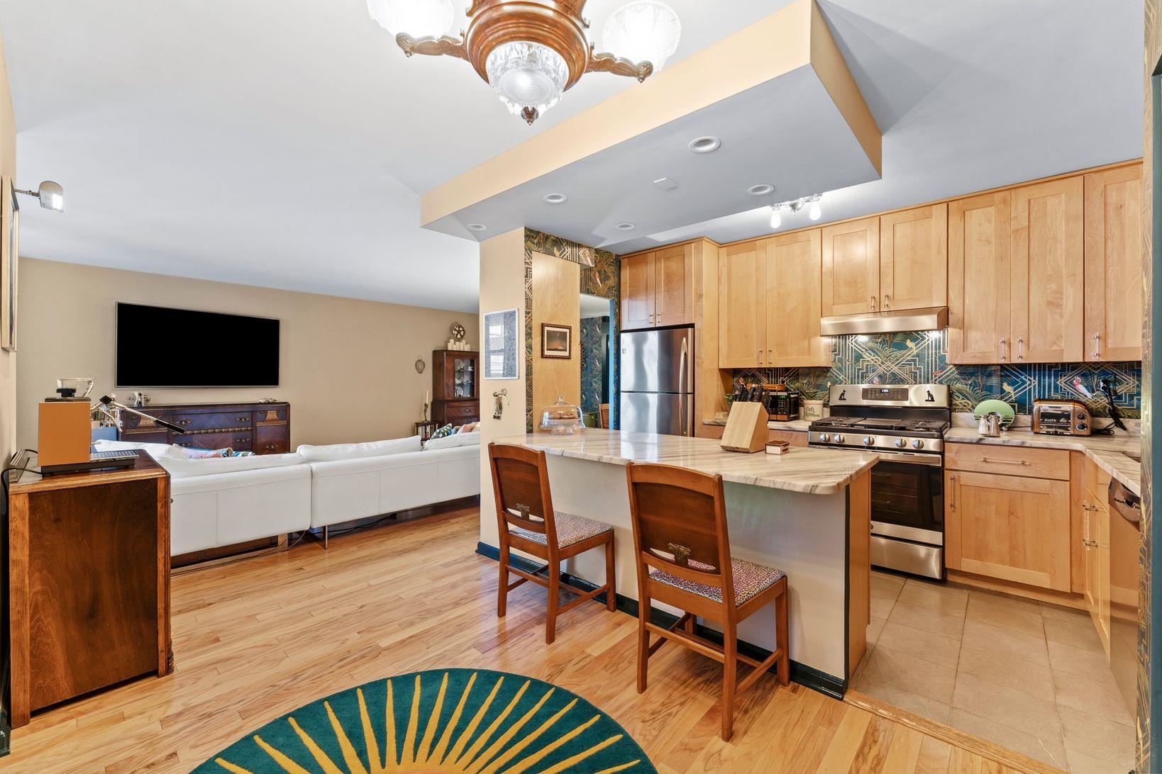 6040 Boulevard East, Unit MA West New York, NJ 07093 - Photo 17 of 35 a living room with furniture flat screen tv and kitchen view