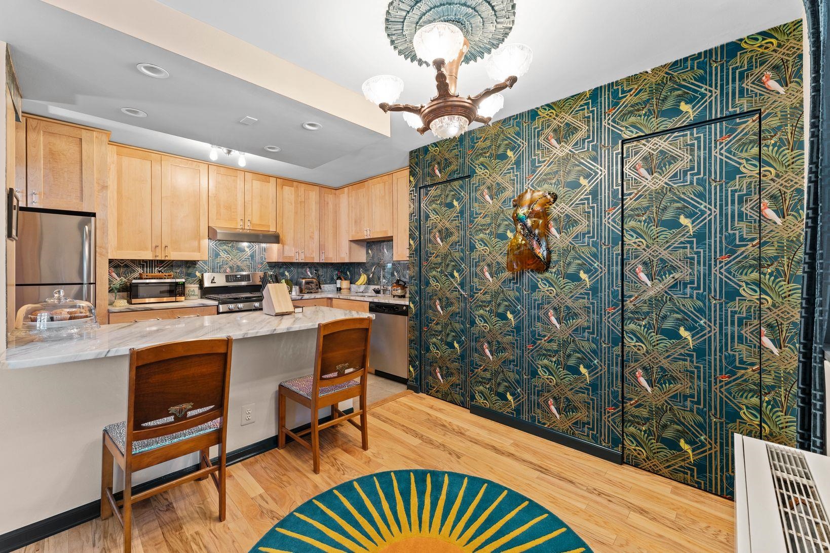 6040 Boulevard East, Unit MA West New York, NJ 07093 - Photo 18 of 35 a kitchen with stainless steel appliances granite countertop a sink a stove a chimney a refrigerator and cabinets