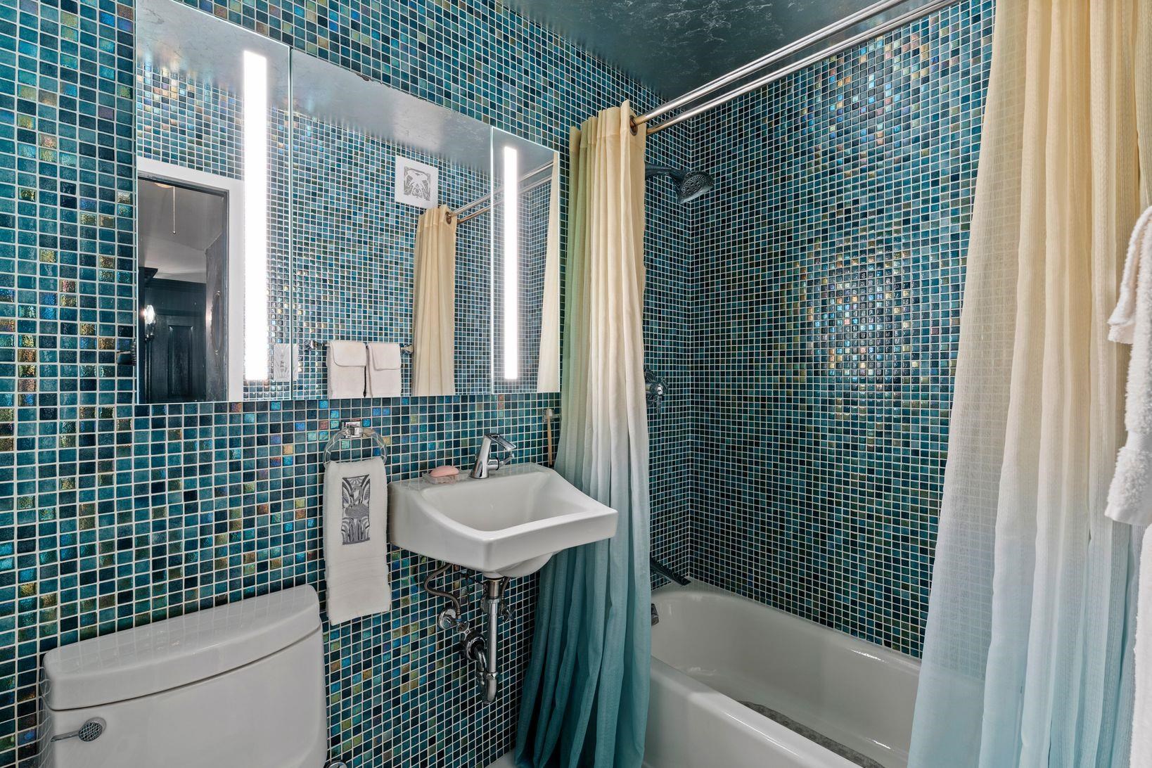 6040 Boulevard East, Unit MA West New York, NJ 07093 - Photo 23 of 35 a bathroom with a sink a toilet and shower