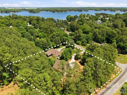 an aerial view of a houses with a lake view