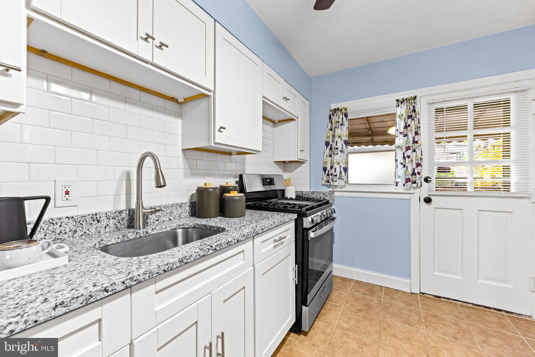 3807 Kimble Road Baltimore, MD 21218 - Photo 11 of 39 a kitchen with stainless steel appliances granite countertop a sink and a stove