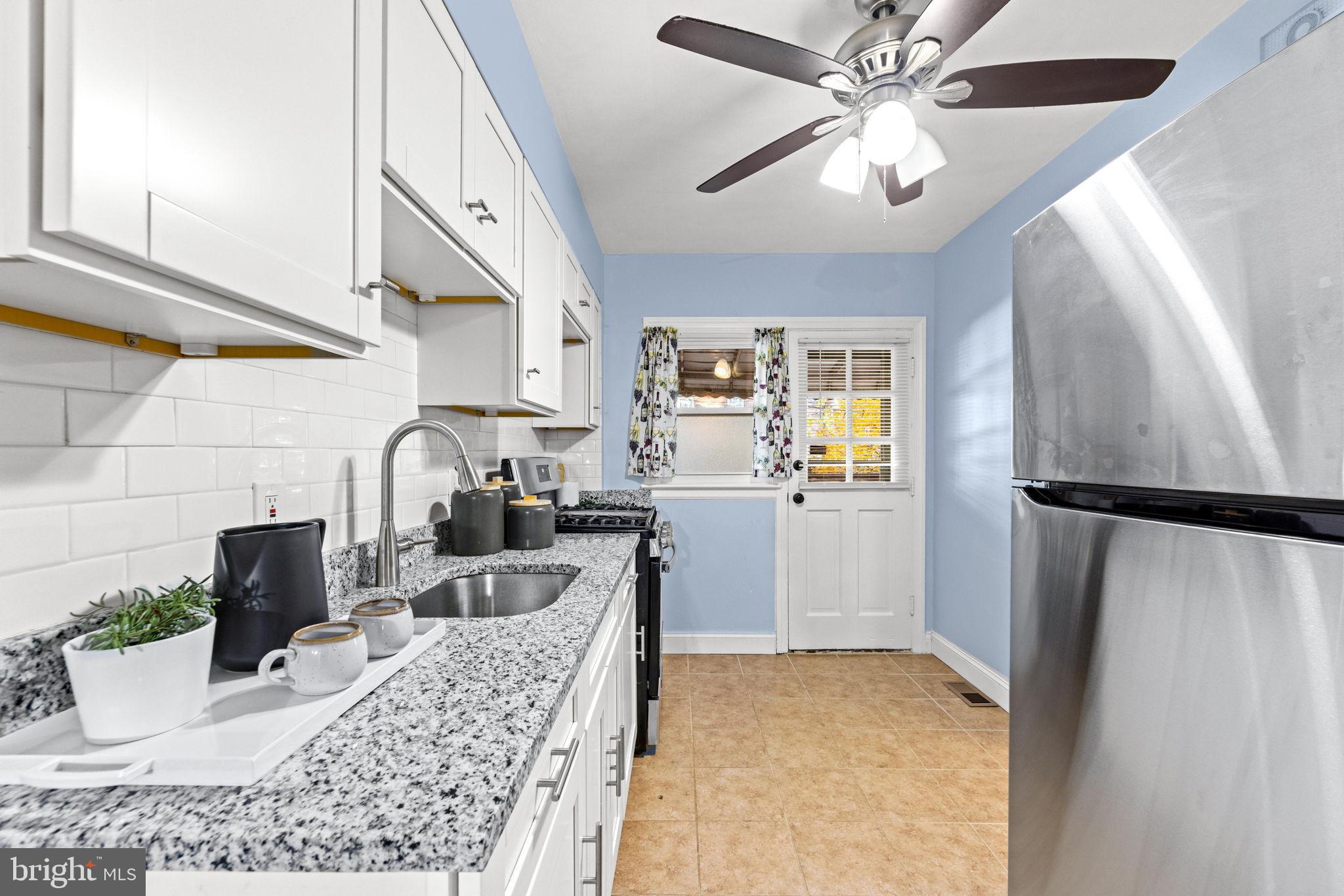 3807 Kimble Road Baltimore, MD 21218 - Photo 14 of 39 a kitchen with a refrigerator and a sink