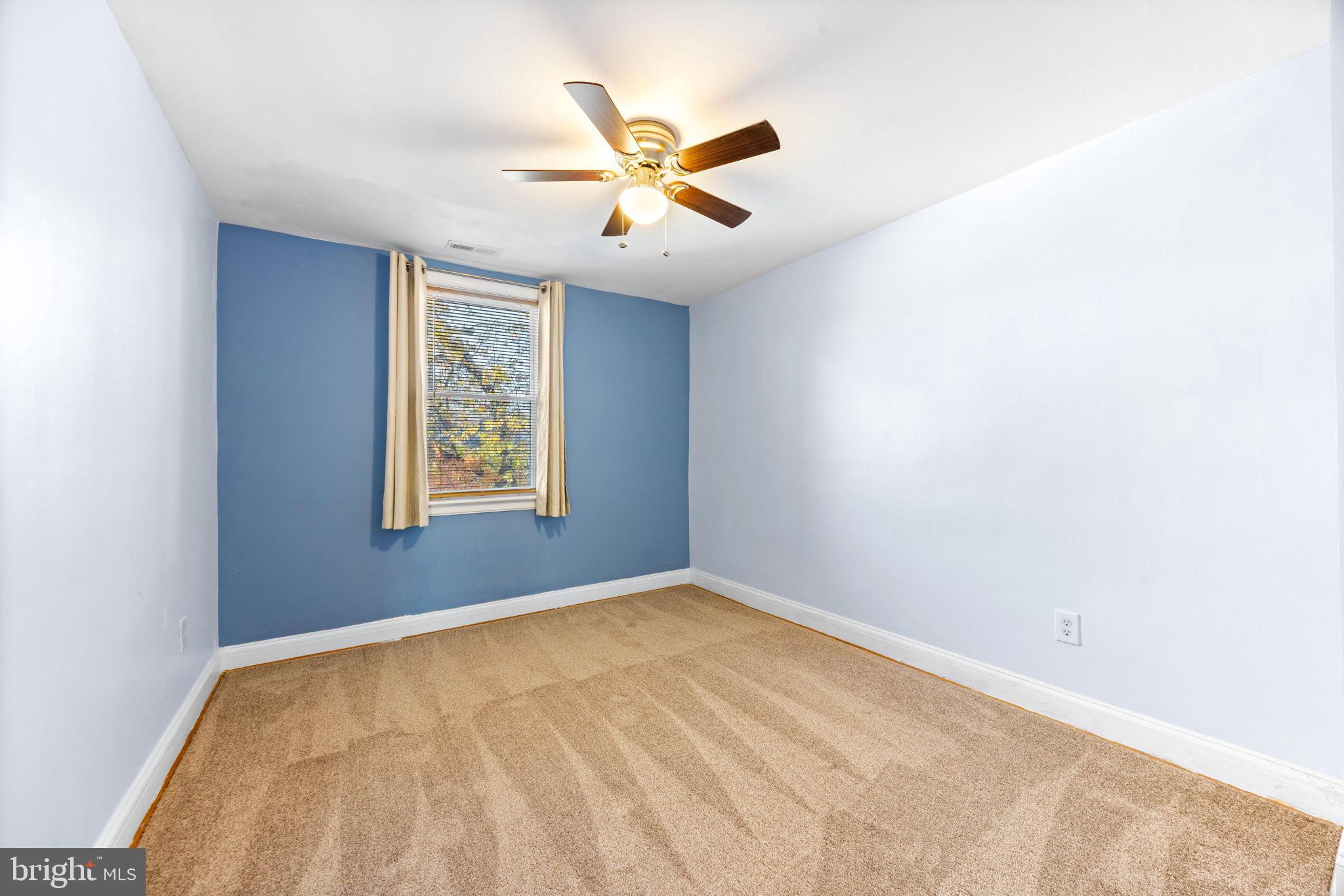 3807 Kimble Road Baltimore, MD 21218 - Photo 19 of 39 an empty room with window and ceiling fan