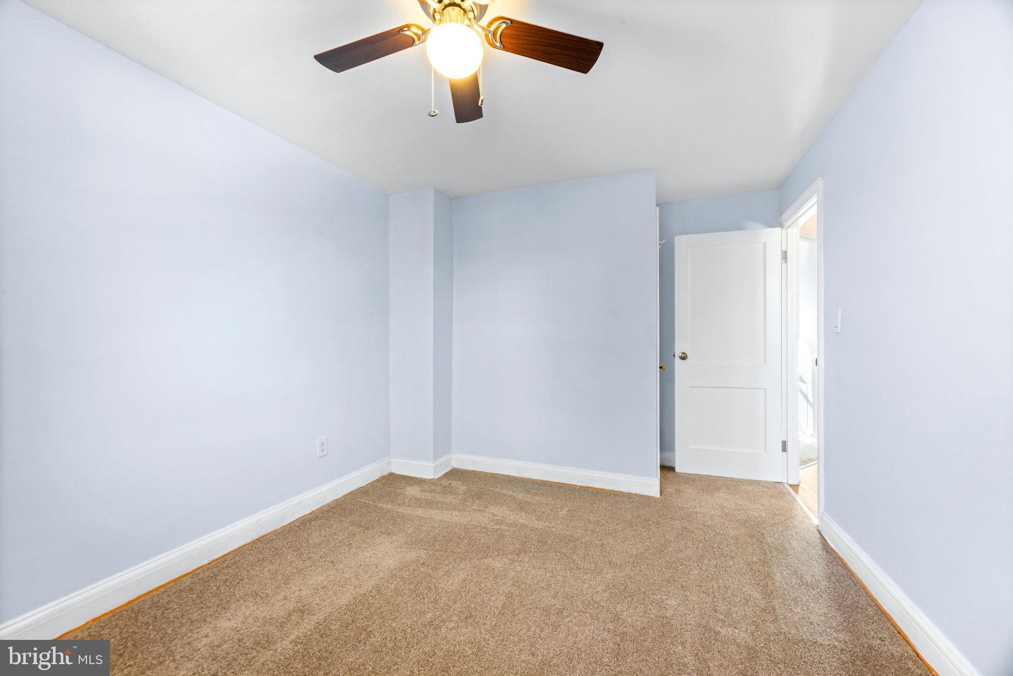 3807 Kimble Road Baltimore, MD 21218 - Photo 20 of 39 an empty room with a ceiling fan and carpet
